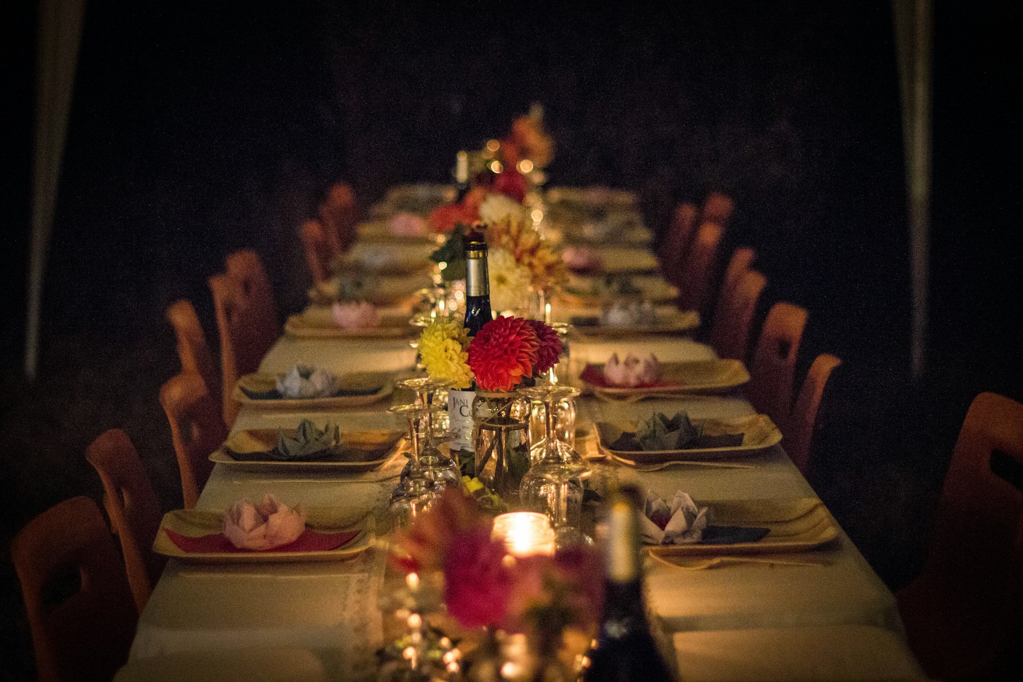 A long dinner-party table set with flowers and candles