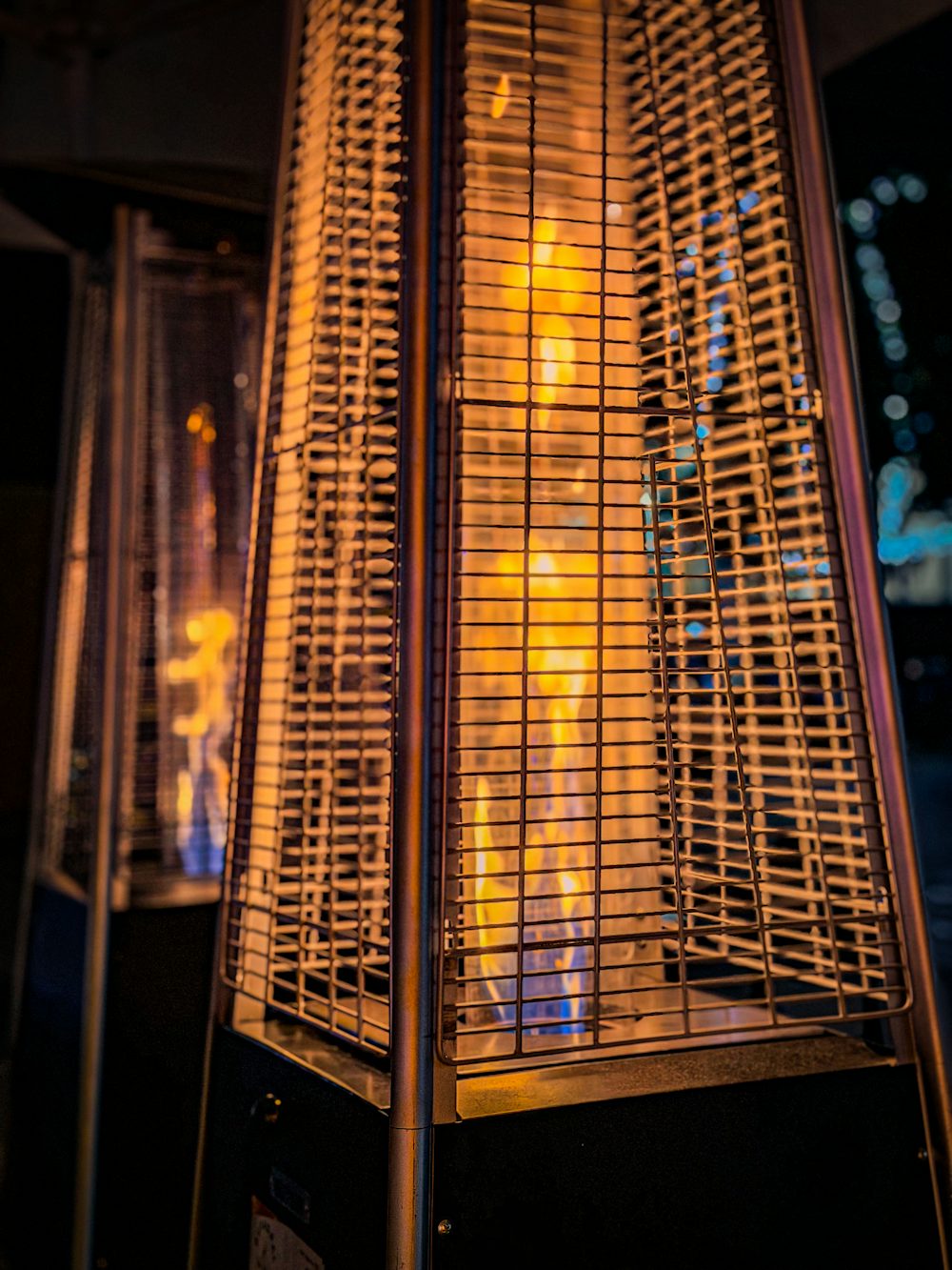 An outdoor patio heater glowing at night